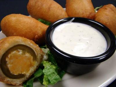 Jalapeno peppers are stuffed with two cheeses, deep-fried and served with Ranch dressing.